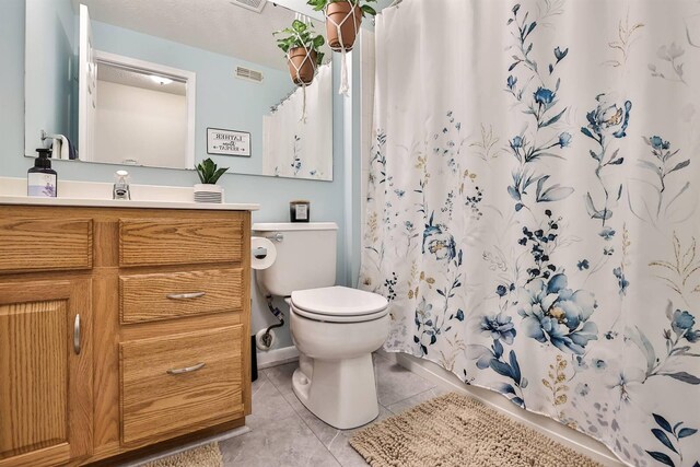 bathroom featuring vanity, visible vents, tile patterned flooring, curtained shower, and toilet