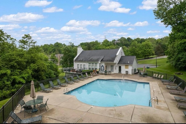 pool with fence and a patio area