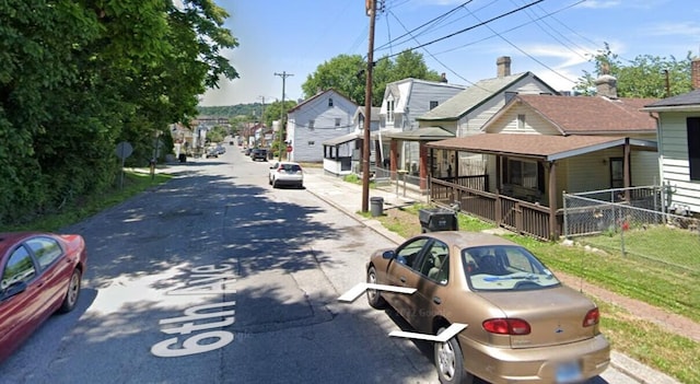 view of road featuring a residential view, curbs, and sidewalks