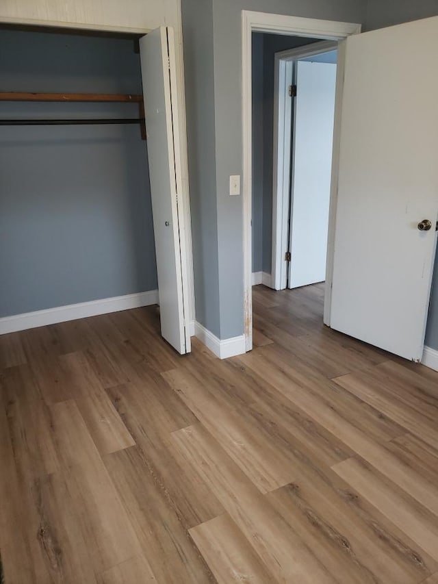 unfurnished bedroom featuring baseboards and wood finished floors