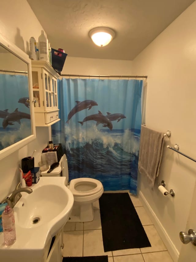 full bath featuring curtained shower, tile patterned floors, and toilet