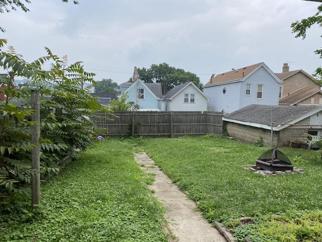 view of yard featuring a fire pit and fence