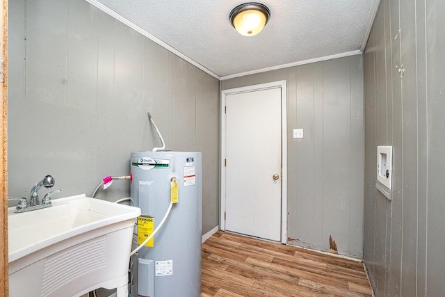 utility room featuring a sink and water heater