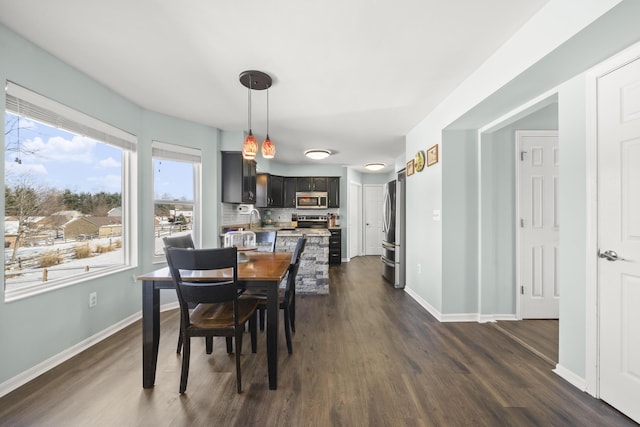 dining space with dark wood-style floors and baseboards