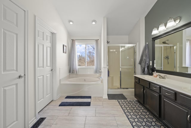 bathroom with a bath, visible vents, a stall shower, and vanity