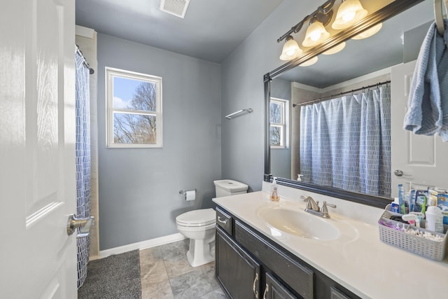 bathroom with visible vents, toilet, vanity, and baseboards