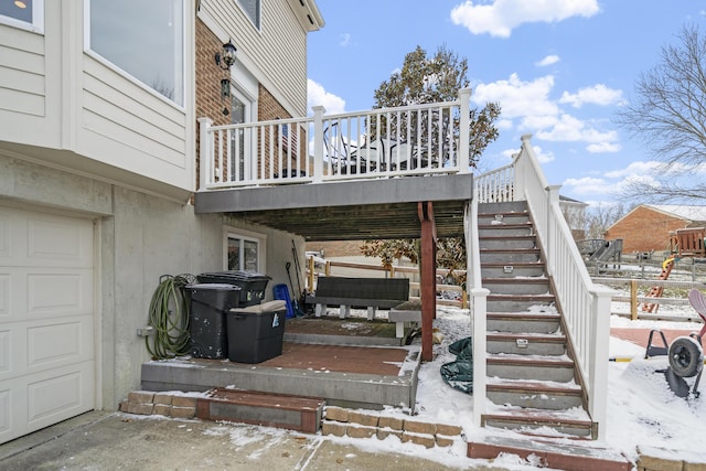 exterior space with stairway, a garage, and a deck