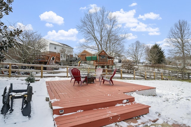 snow covered deck featuring an outdoor fire pit