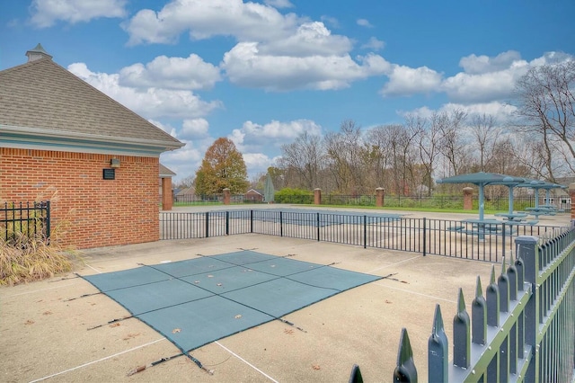 view of pool with a patio area, a fenced in pool, and fence