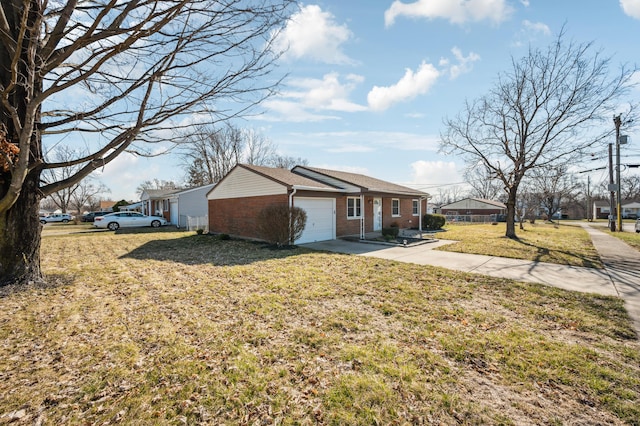 view of front of home featuring a front yard, concrete driveway, brick siding, and an attached garage