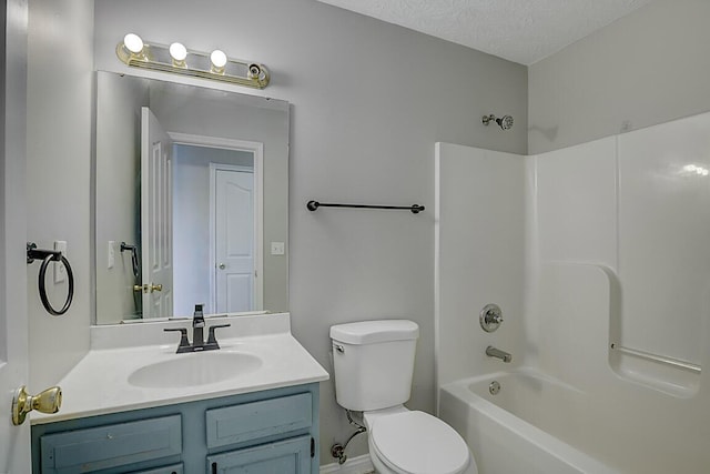 full bathroom featuring toilet, a textured ceiling, vanity, and shower / bath combination