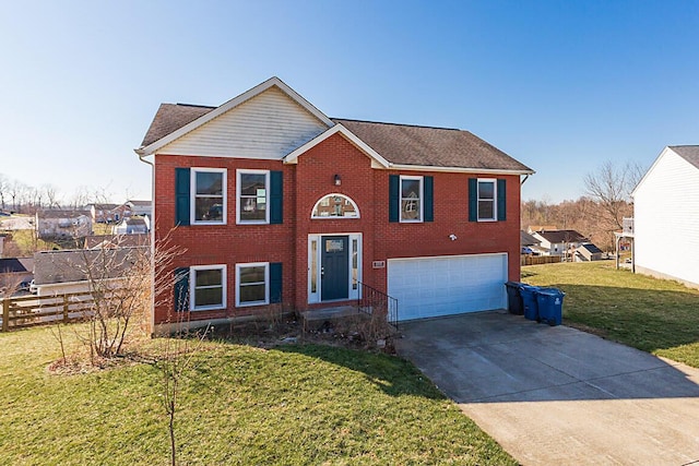 bi-level home featuring driveway, fence, a front yard, a garage, and brick siding