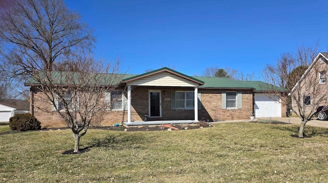 ranch-style home featuring a front yard, brick siding, a garage, and driveway