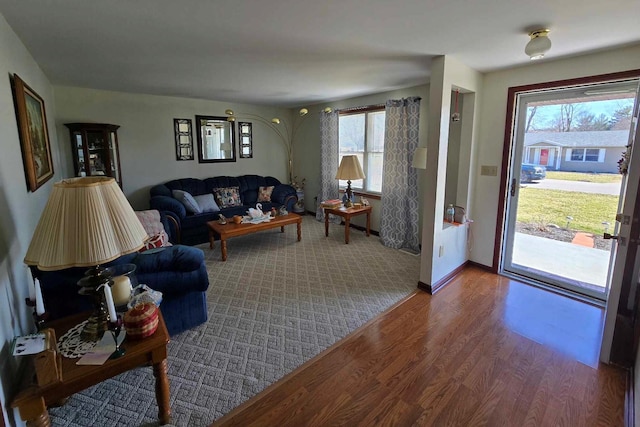 living room featuring baseboards and wood finished floors