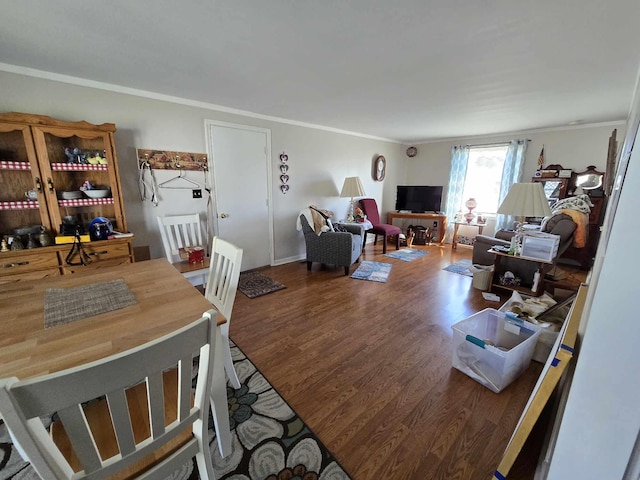 dining room with wood finished floors and ornamental molding