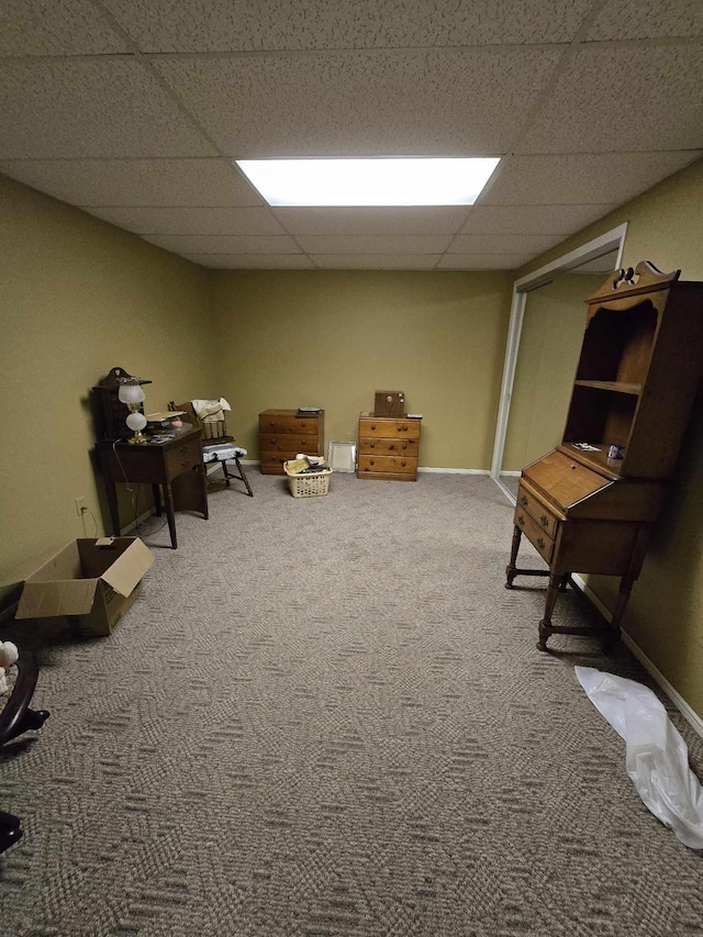 carpeted office featuring a paneled ceiling and baseboards