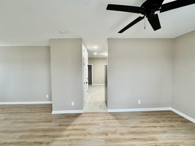 empty room featuring recessed lighting, light wood-type flooring, baseboards, and a ceiling fan