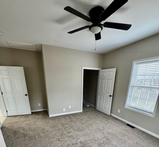 unfurnished bedroom with visible vents, baseboards, ceiling fan, and carpet flooring