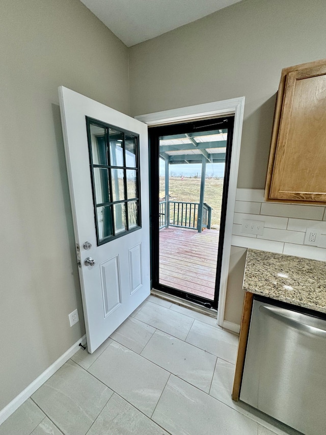 doorway featuring baseboards