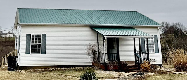 rear view of property with metal roof