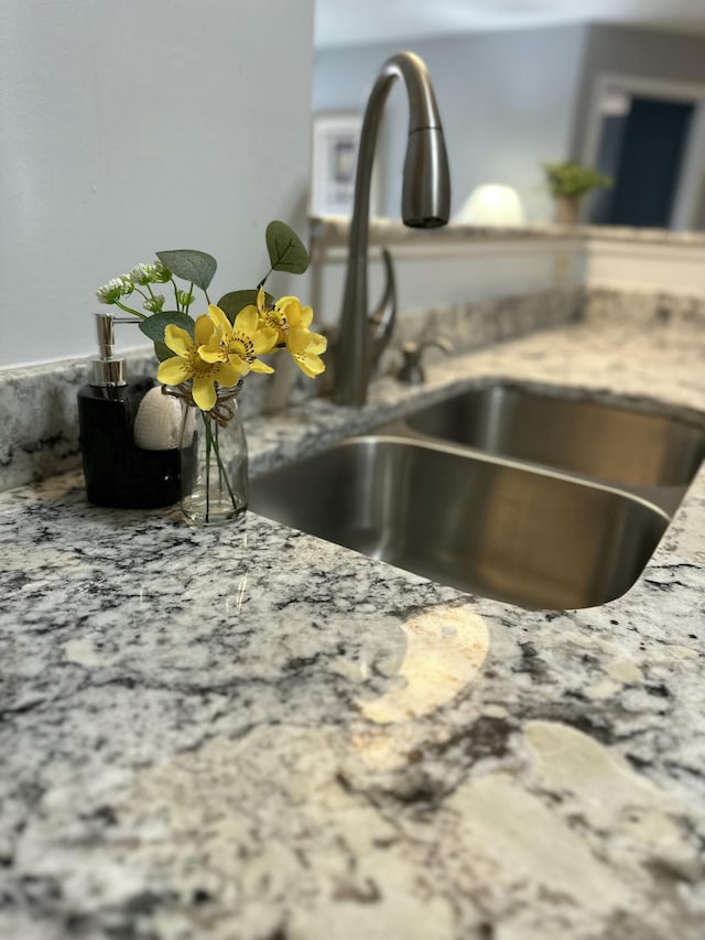 room details with a sink and light stone counters