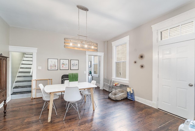 dining space featuring stairway, baseboards, and dark wood-style flooring