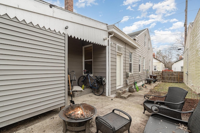 exterior space with a fire pit and fence