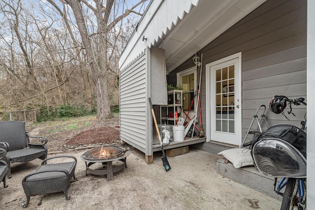 view of patio featuring fence and an outdoor fire pit