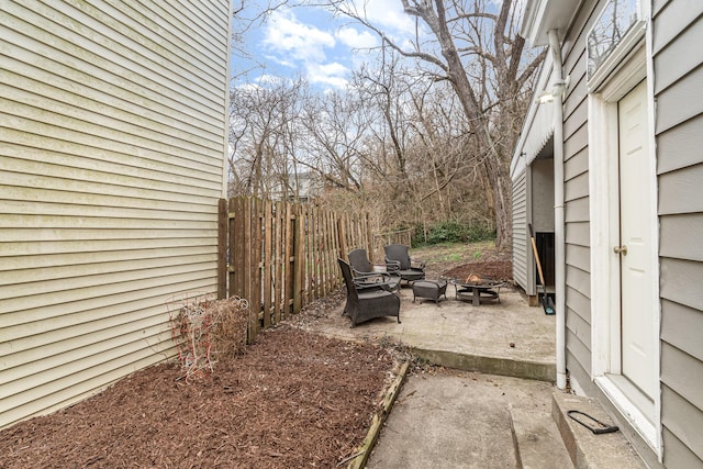 view of yard with a fire pit, a patio, and fence