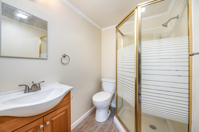 full bathroom featuring vanity, wood finished floors, a stall shower, a textured ceiling, and toilet