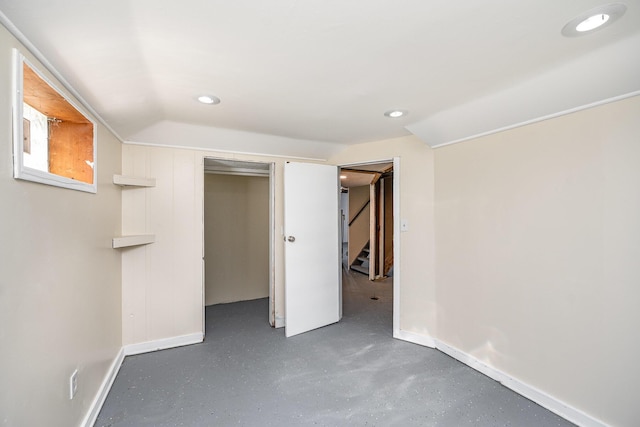 unfurnished bedroom featuring finished concrete floors, recessed lighting, and baseboards