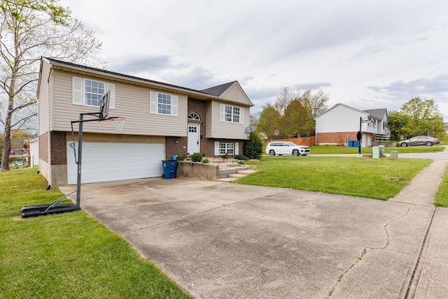 raised ranch featuring a garage, driveway, brick siding, and a front lawn