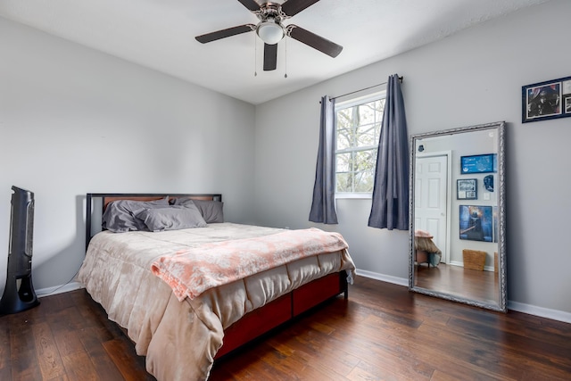 bedroom with a ceiling fan, baseboards, and hardwood / wood-style flooring