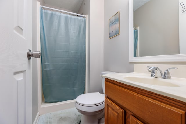 bathroom featuring curtained shower, toilet, and vanity