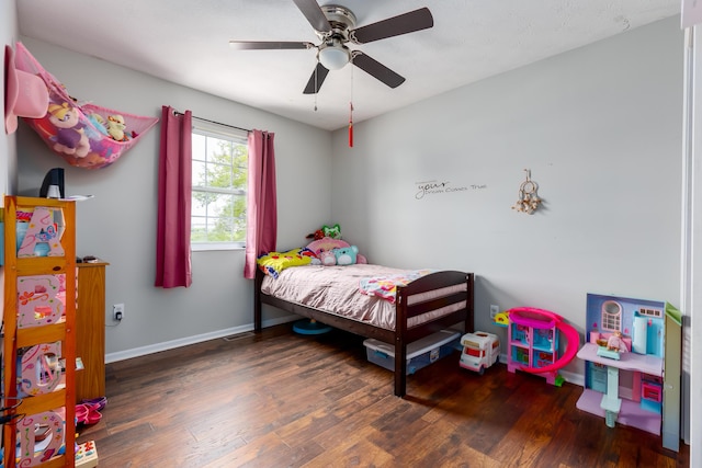 bedroom with wood finished floors, baseboards, and ceiling fan