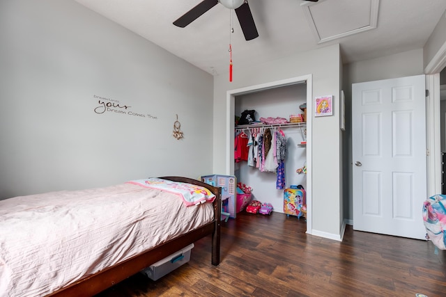 bedroom with a closet, attic access, wood finished floors, and a ceiling fan