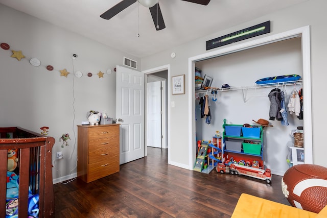 bedroom featuring visible vents, baseboards, a ceiling fan, and wood finished floors