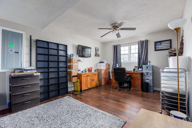 office featuring electric panel, dark wood-style floors, a textured ceiling, and ceiling fan