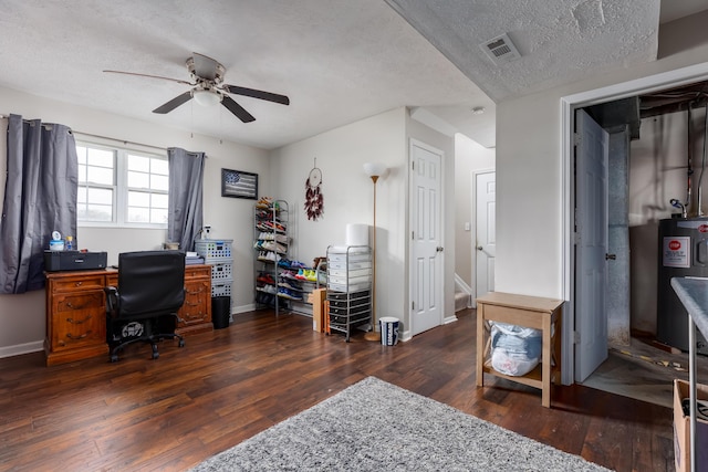 home office with baseboards, water heater, a textured ceiling, a ceiling fan, and wood-type flooring