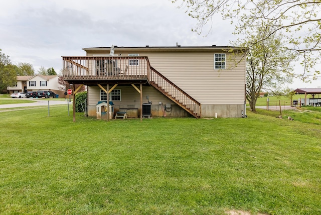 rear view of property featuring a lawn, central AC unit, a deck, and stairs