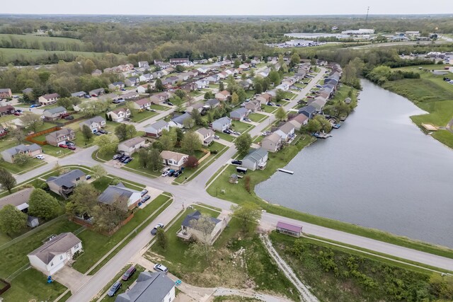 drone / aerial view featuring a residential view and a water view