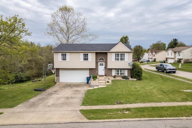 raised ranch with brick siding, a garage, concrete driveway, and a front yard