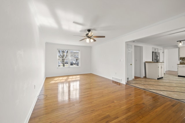 unfurnished living room with crown molding, visible vents, light wood finished floors, and ceiling fan