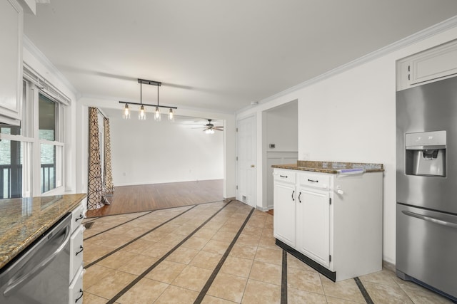 kitchen featuring light tile patterned floors, appliances with stainless steel finishes, crown molding, and a ceiling fan