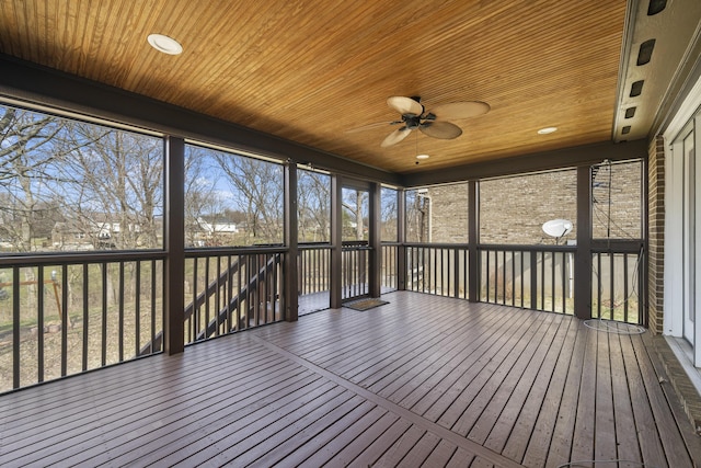 unfurnished sunroom with ceiling fan and wooden ceiling