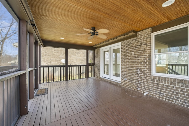 unfurnished sunroom featuring wooden ceiling and a ceiling fan