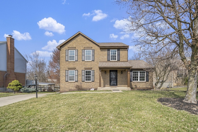 view of front of home with brick siding, a front yard, and a shingled roof