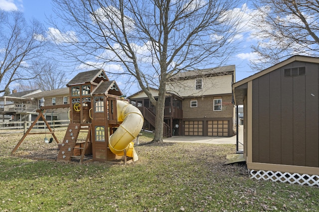 view of play area featuring an outdoor structure, a storage unit, and a yard