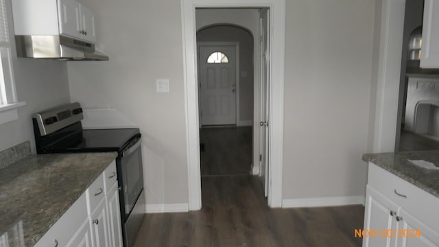 kitchen with under cabinet range hood, dark wood-style floors, white cabinets, and stainless steel range with electric cooktop