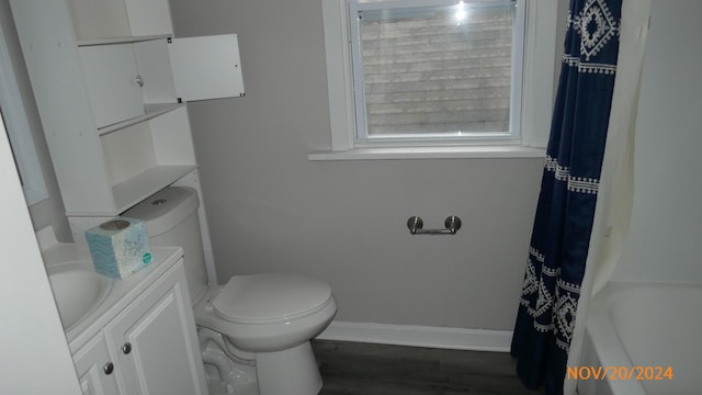 full bath with toilet, vanity, baseboards, and wood finished floors